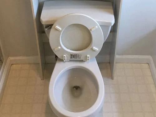 Toilet stained around the base and seat before cleaning